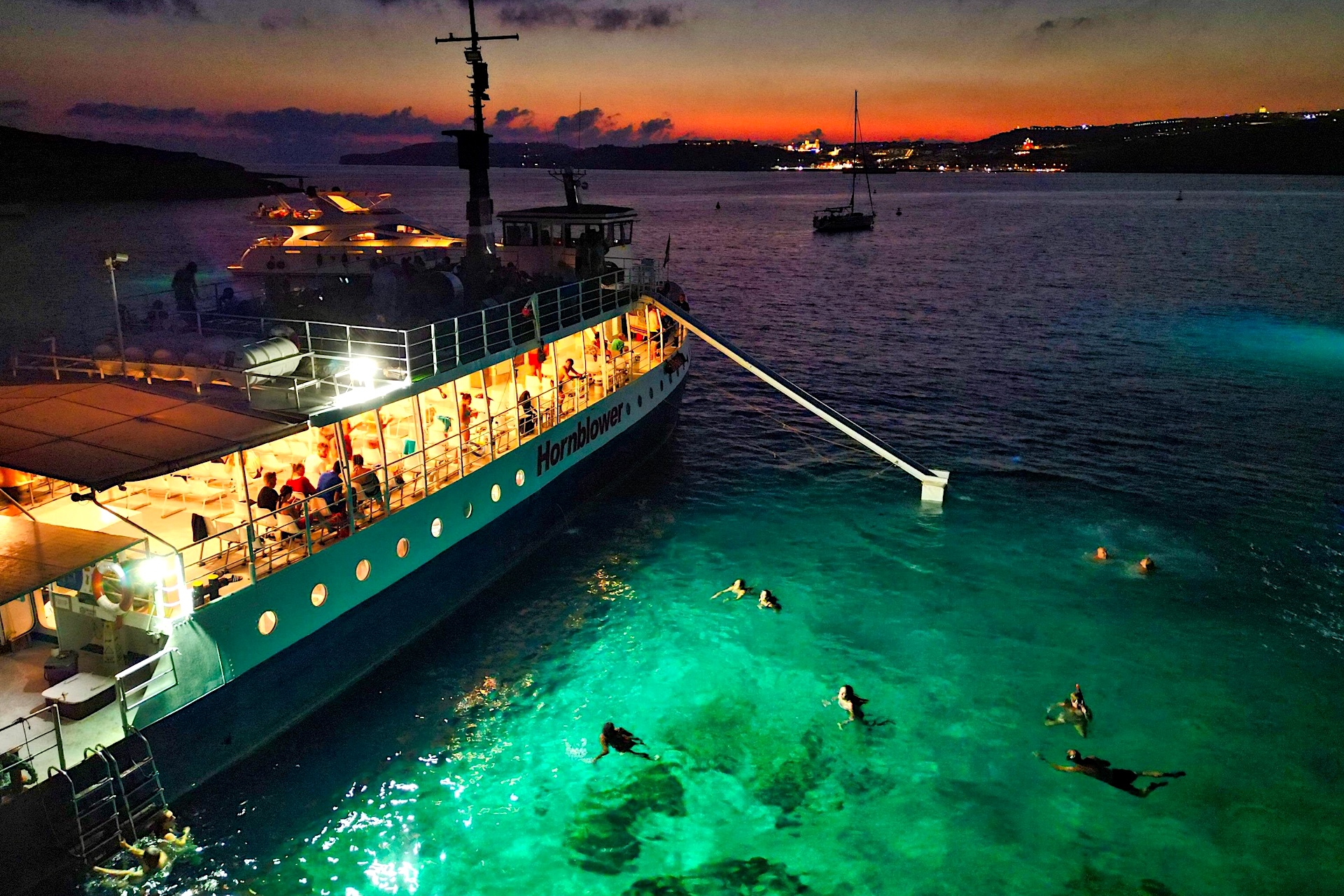 Cruise boat in Malta's Blue Lagoon at night