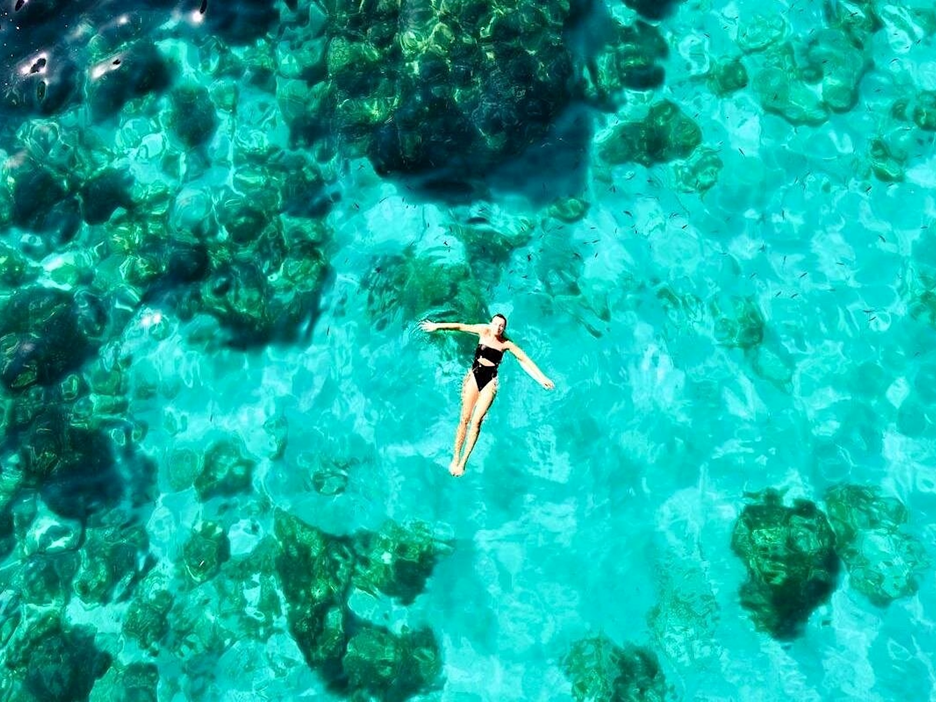 Woman floating on her back in the clear water of the Blue Lagoon
