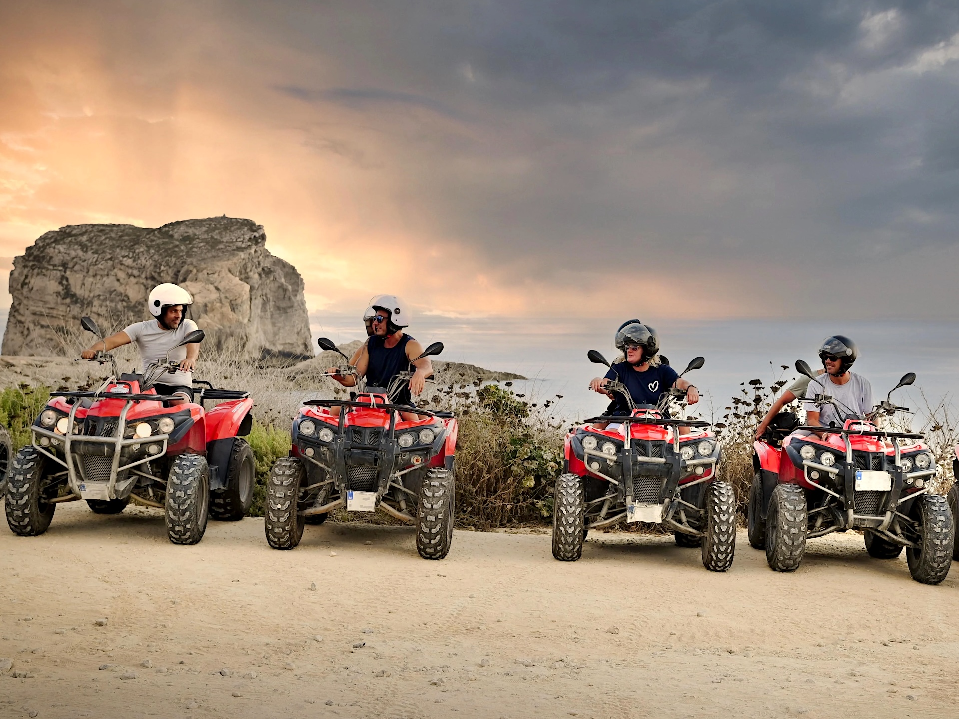 Row of quad bikes lined up facing the Gozo cliff