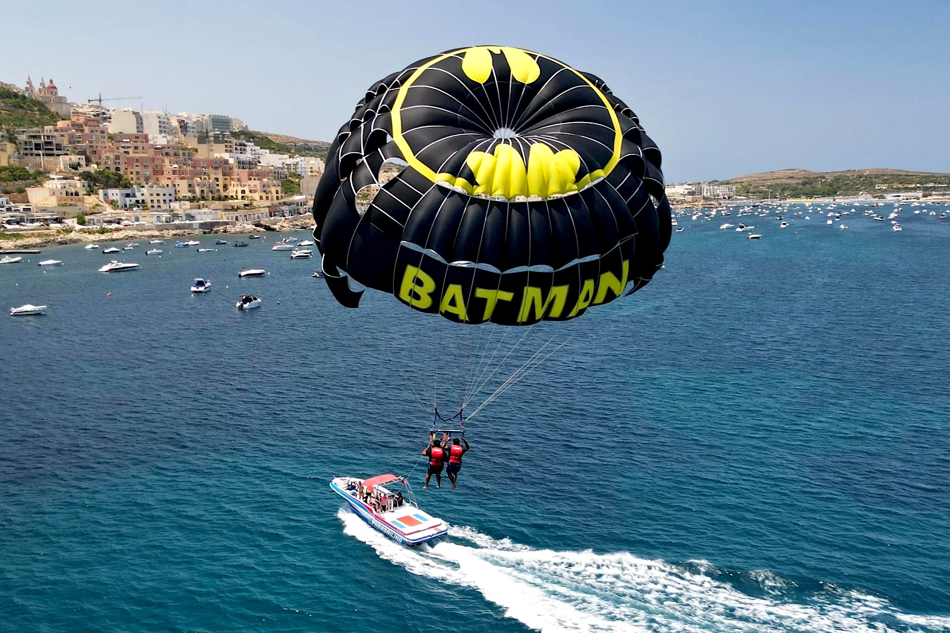 Boat and parasailing with Batman canopy at Mellieħa Bay Malta