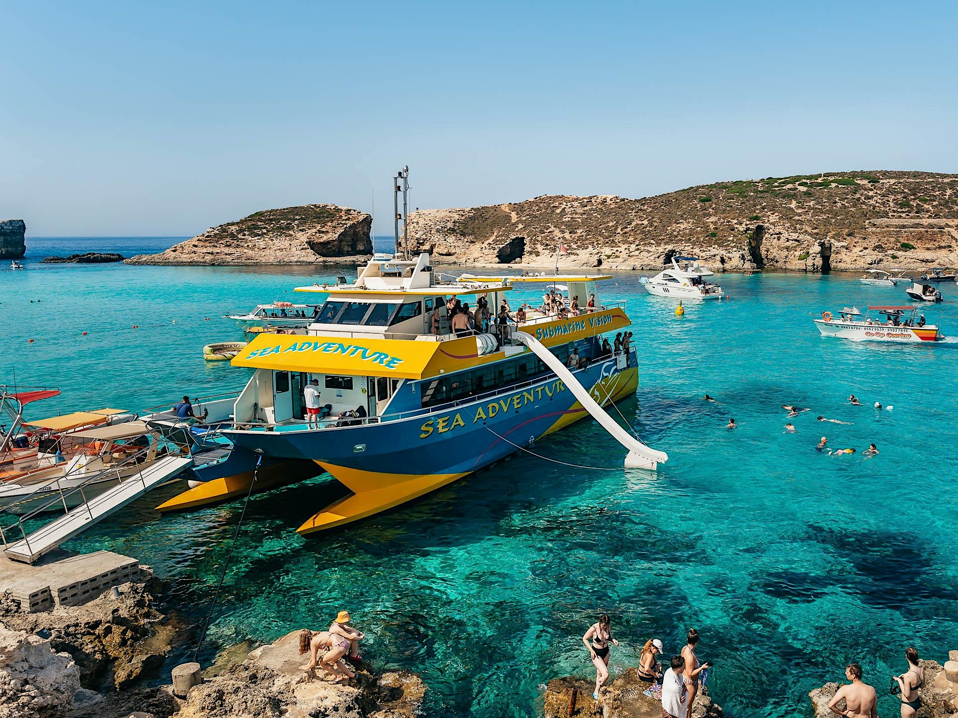 Blue and yellow cruise boat in the Blue Lagoon
