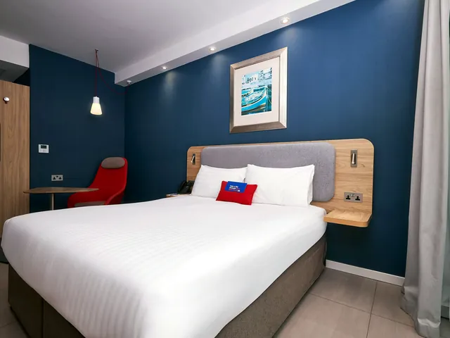Chambre double au mur bleu et au grand lit blanc du Holiday Inn Express Malta