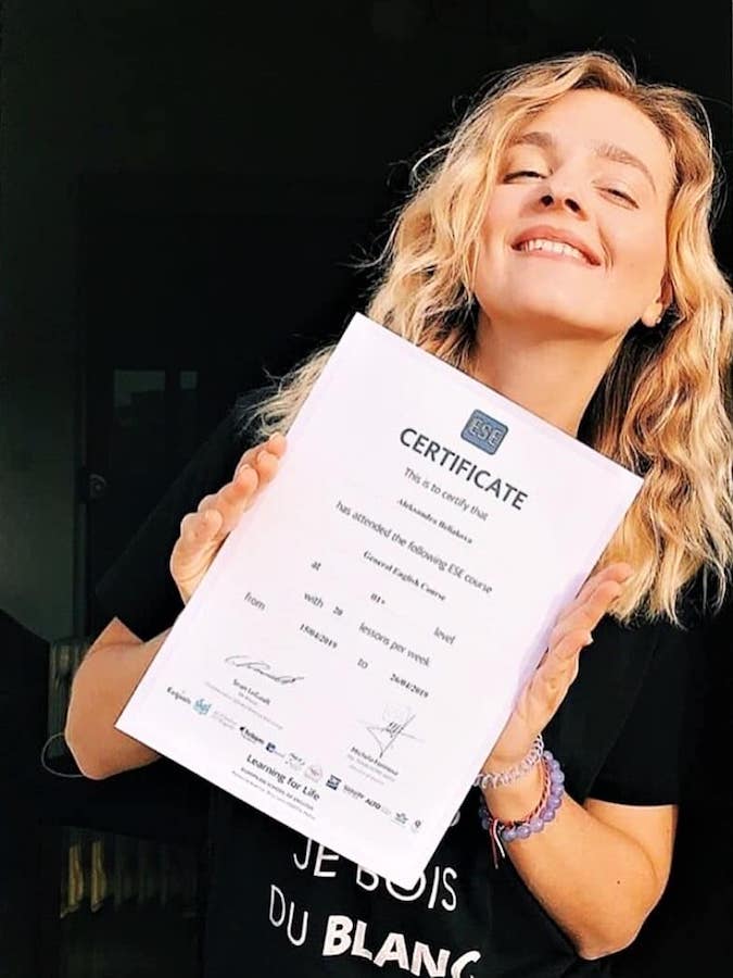 ESE Malta certificate Smiling student holding her ESE English course certificate