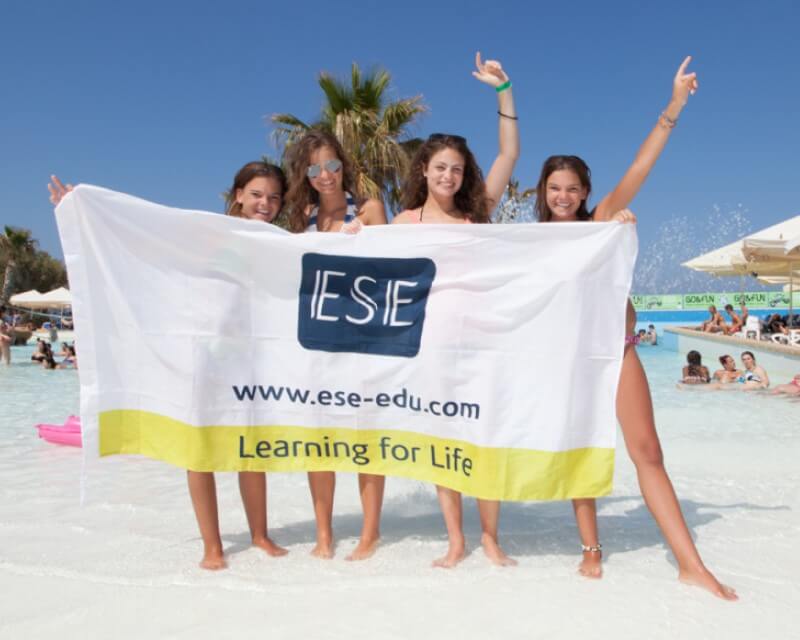 Pool activities at ESE Malta ESE Malta students with the school flag at the Salini Resort pool