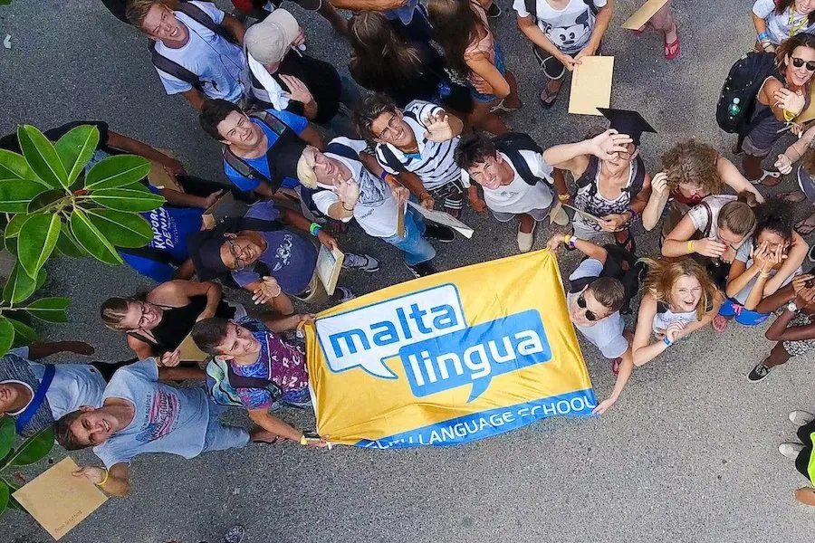Maltalingua Teens Programme A group of Maltalingua teenagers holding the school banner