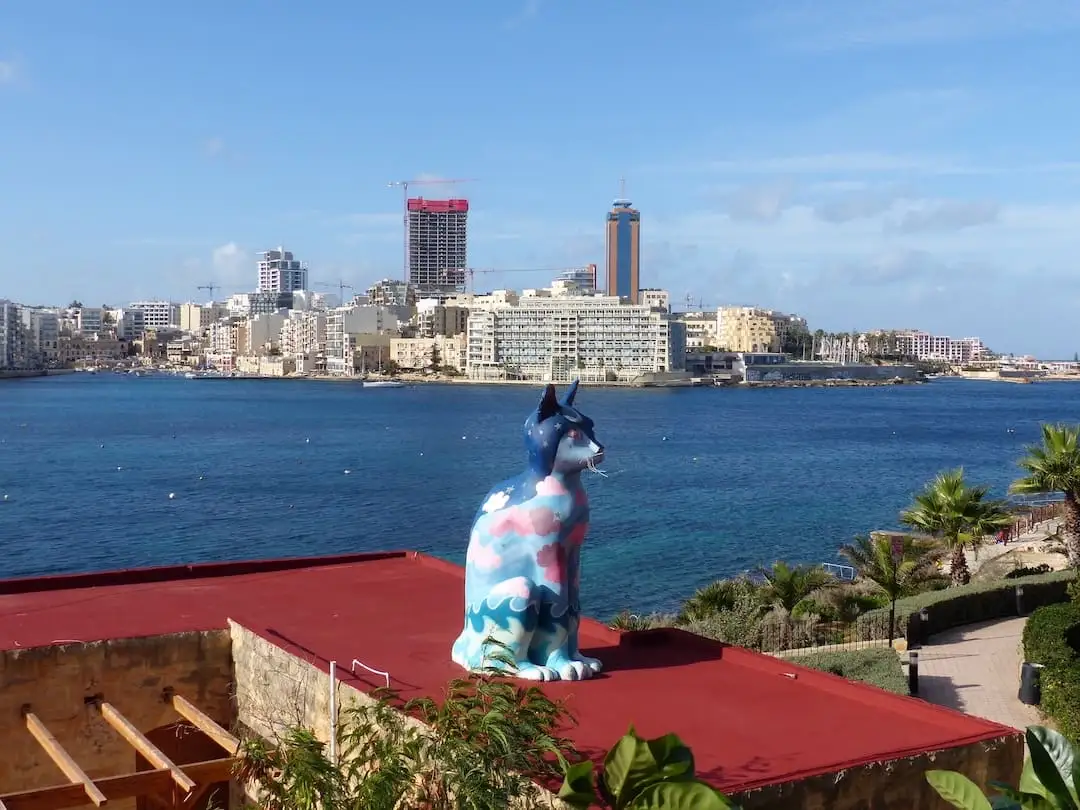 Cat statue with a view of Balluta Bay in Sliema