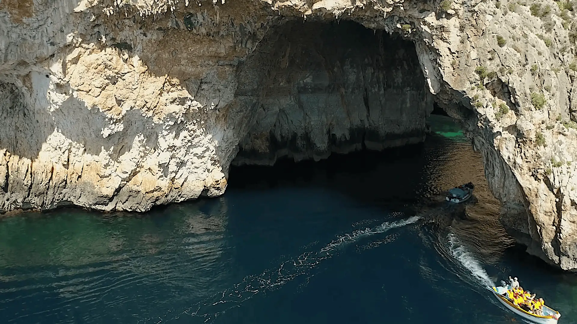 Two boats under the arch of Blue Grotto in Malta