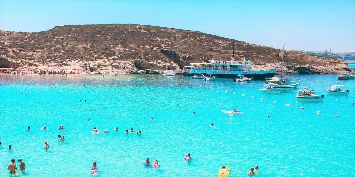Blue lagoon with swimmers and turquoise water