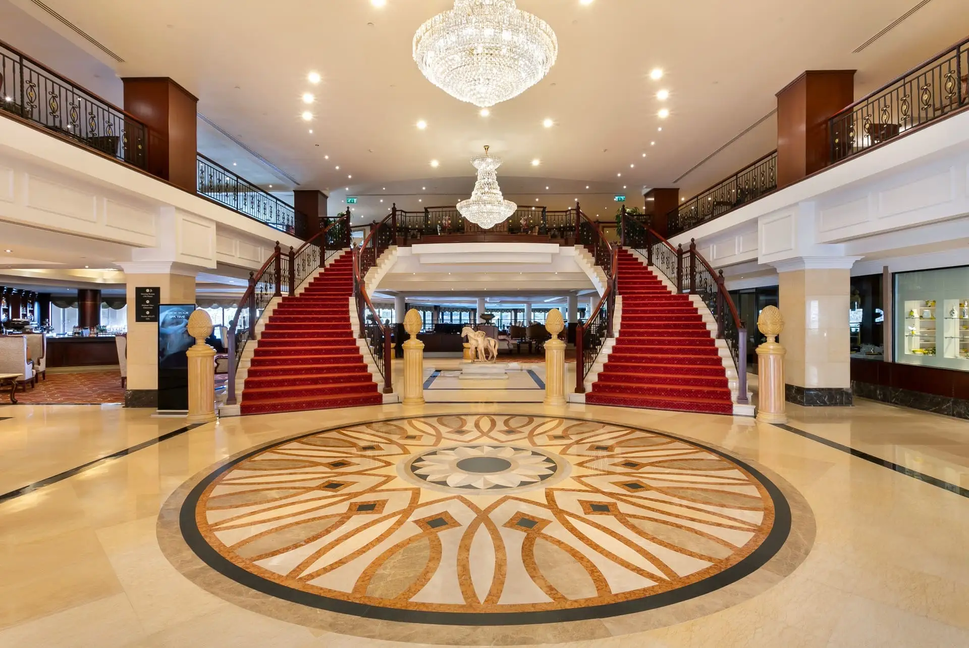 Double staircase with red carpet at the 5-star Grand Hotel Excelsior