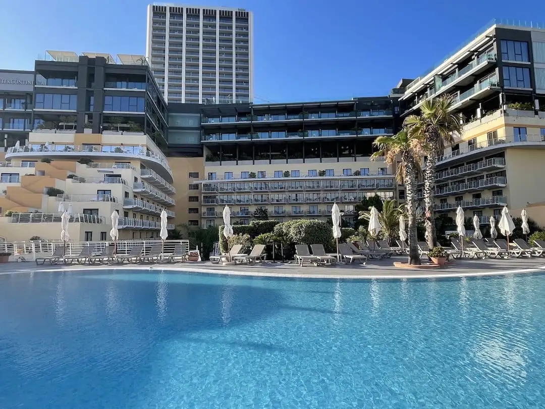 Outdoor pool with buildings in the background