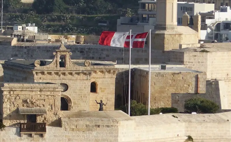 Two Maltese flags waving in the wind