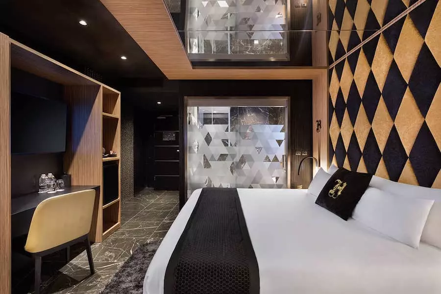 Chambre standard H Hotel, lit double, bureau et salle de bain transparente