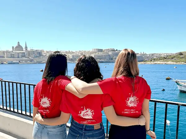 Three members of the IELS team facing Valletta