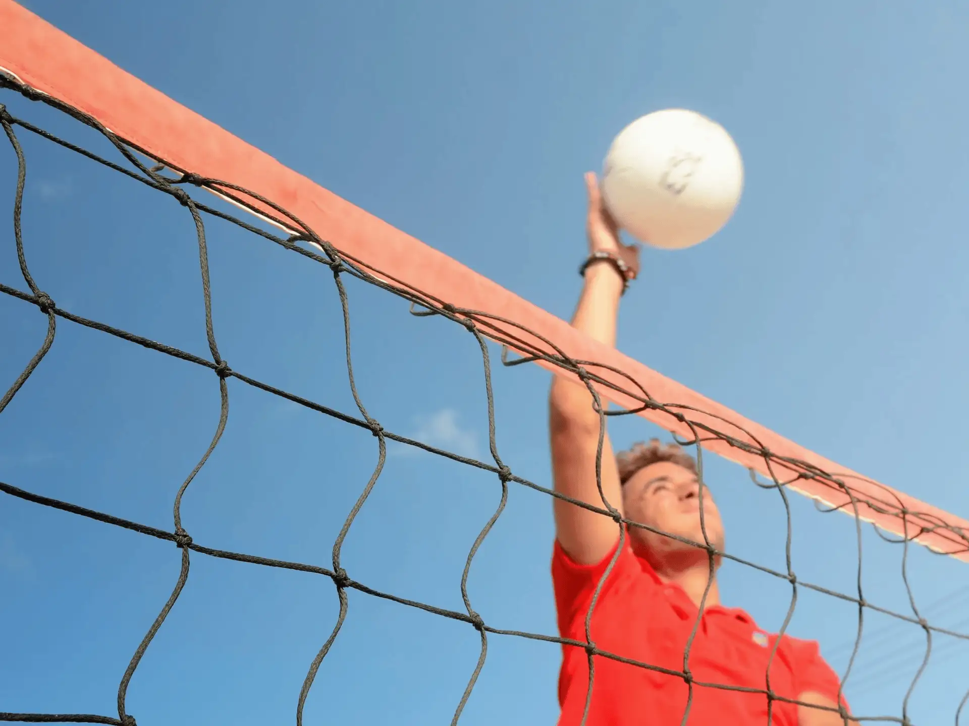 Young person participating in a language stay in Malta playing volleyball on the beach