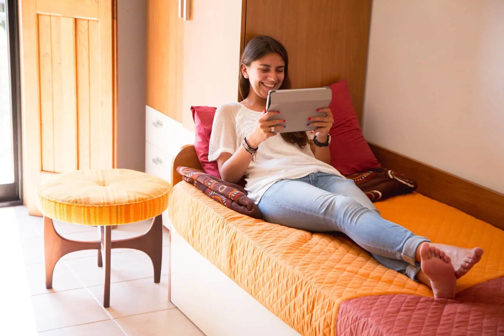 Student relaxing on her bed in an EC Malta host family room