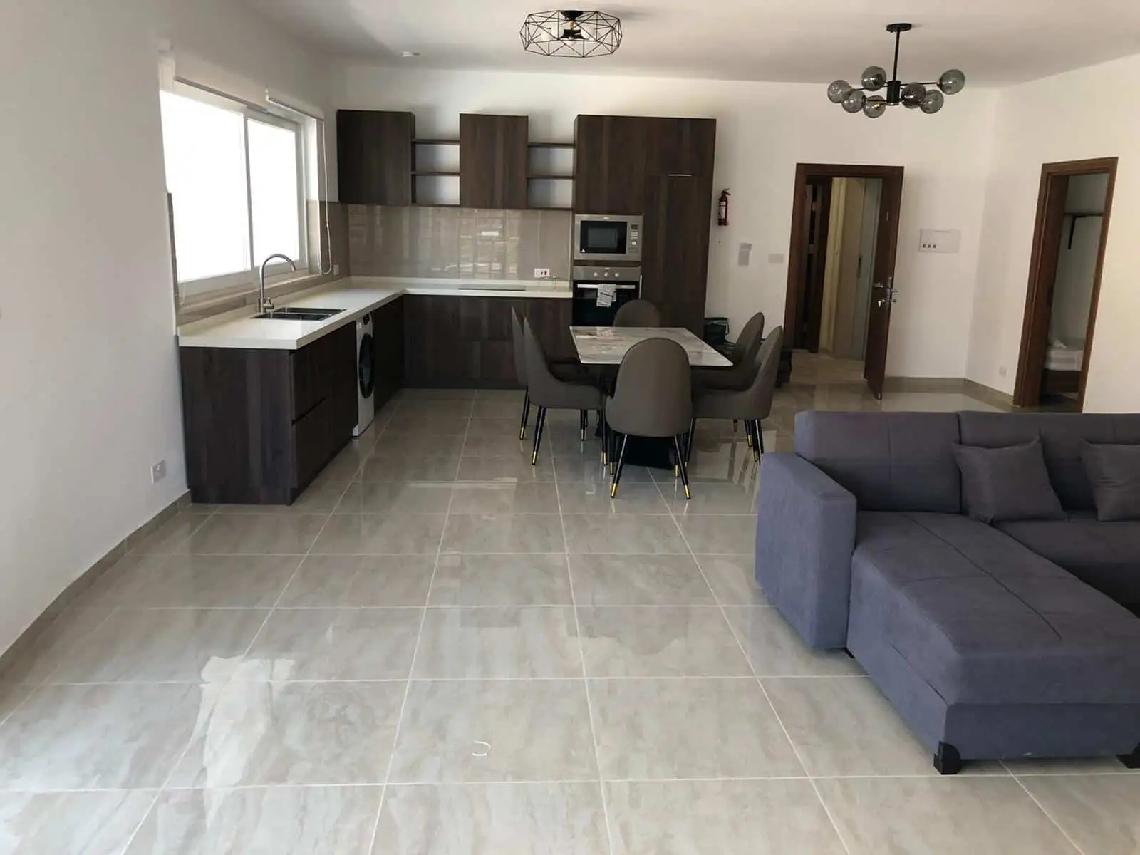 Large bright living room with open kitchen in EC Malta apartment