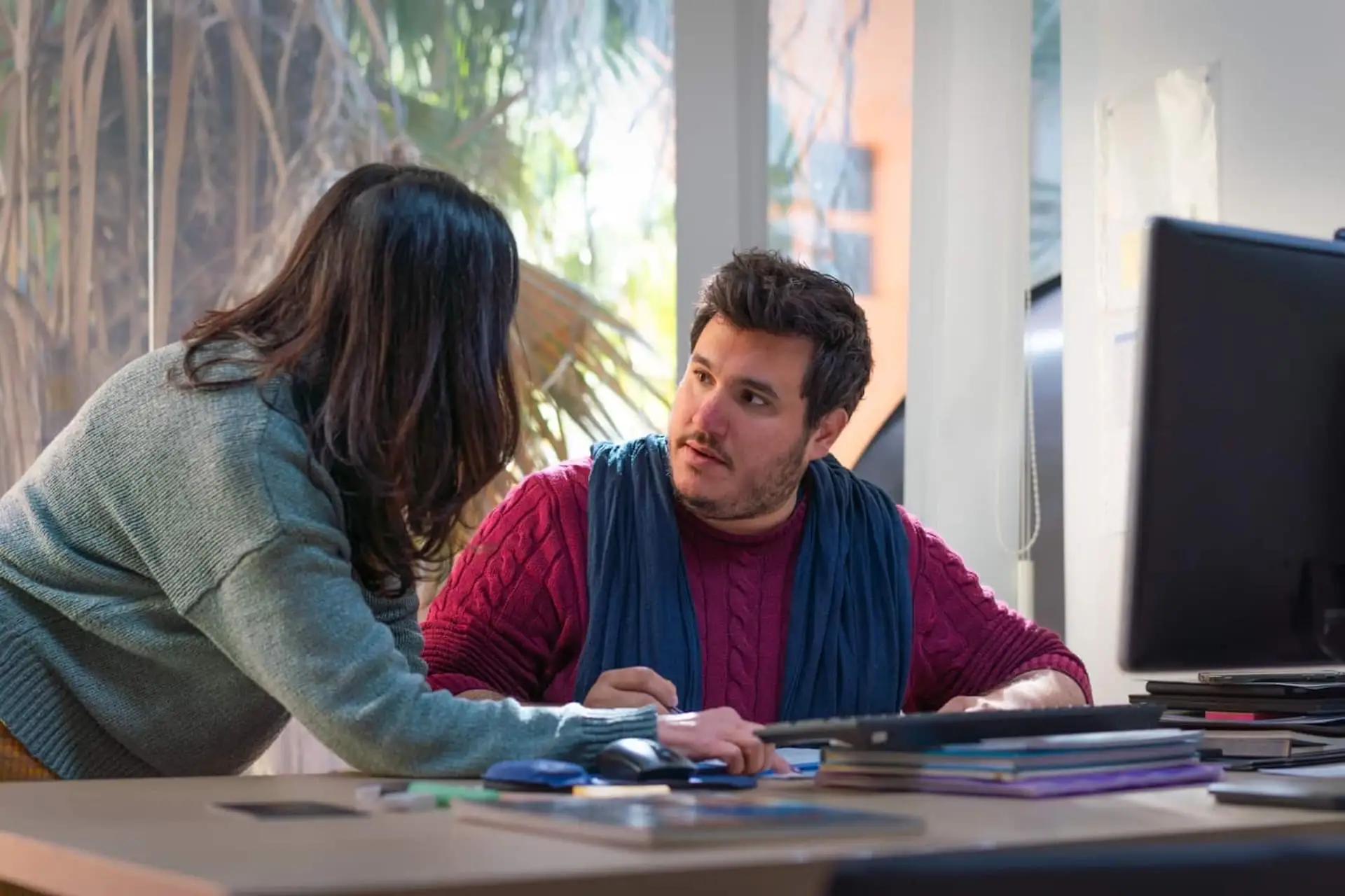 Female and male students discussing with a teacher at EC Malta