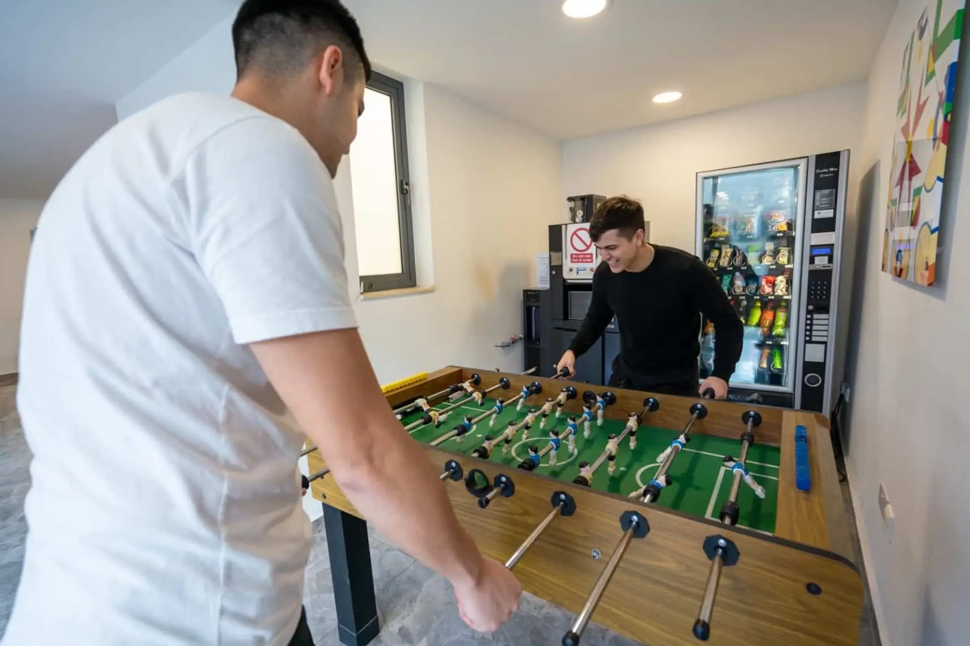 Students playing table football in the EC Malta relaxation area