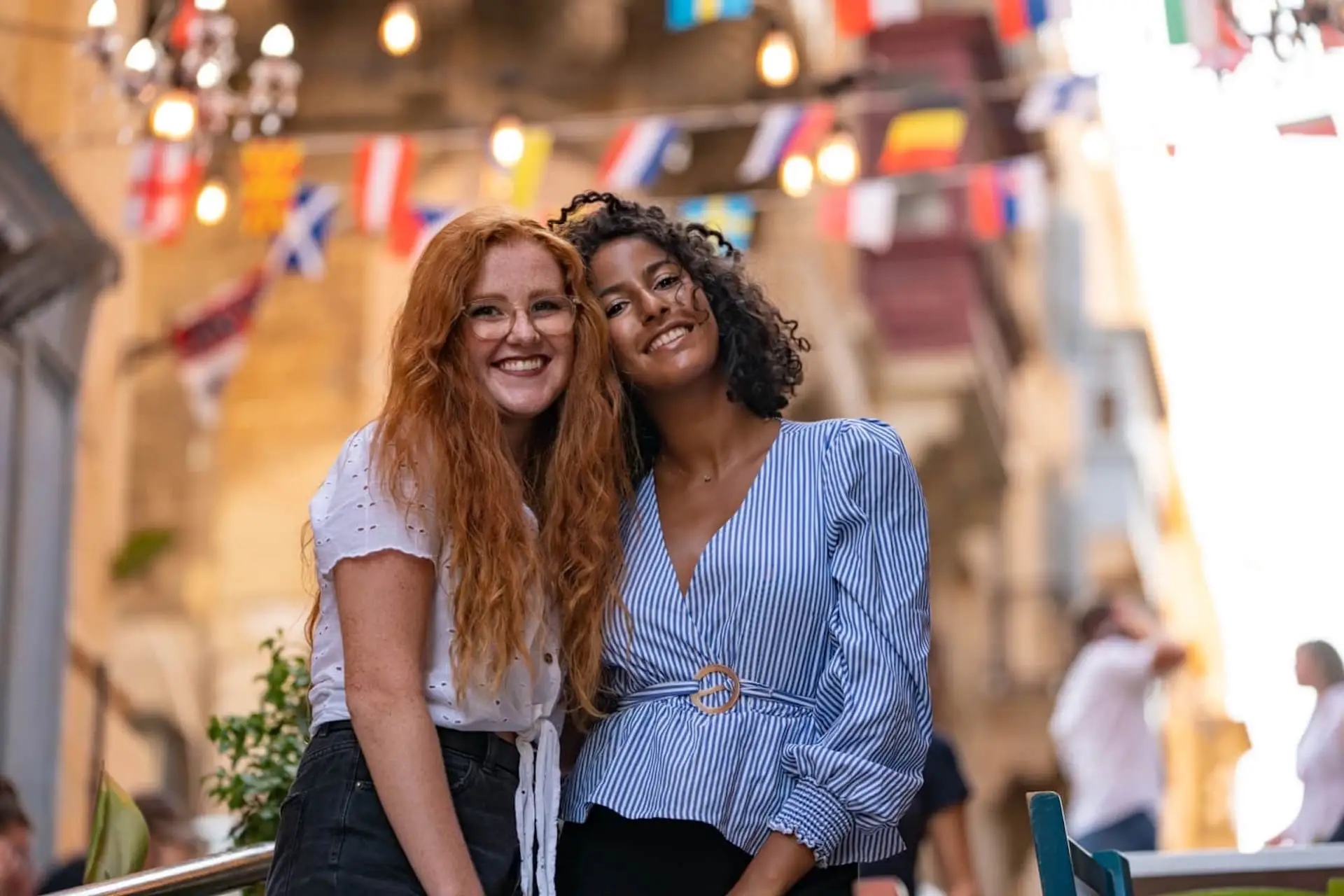 Two smiling female students in the decorated streets of Valletta