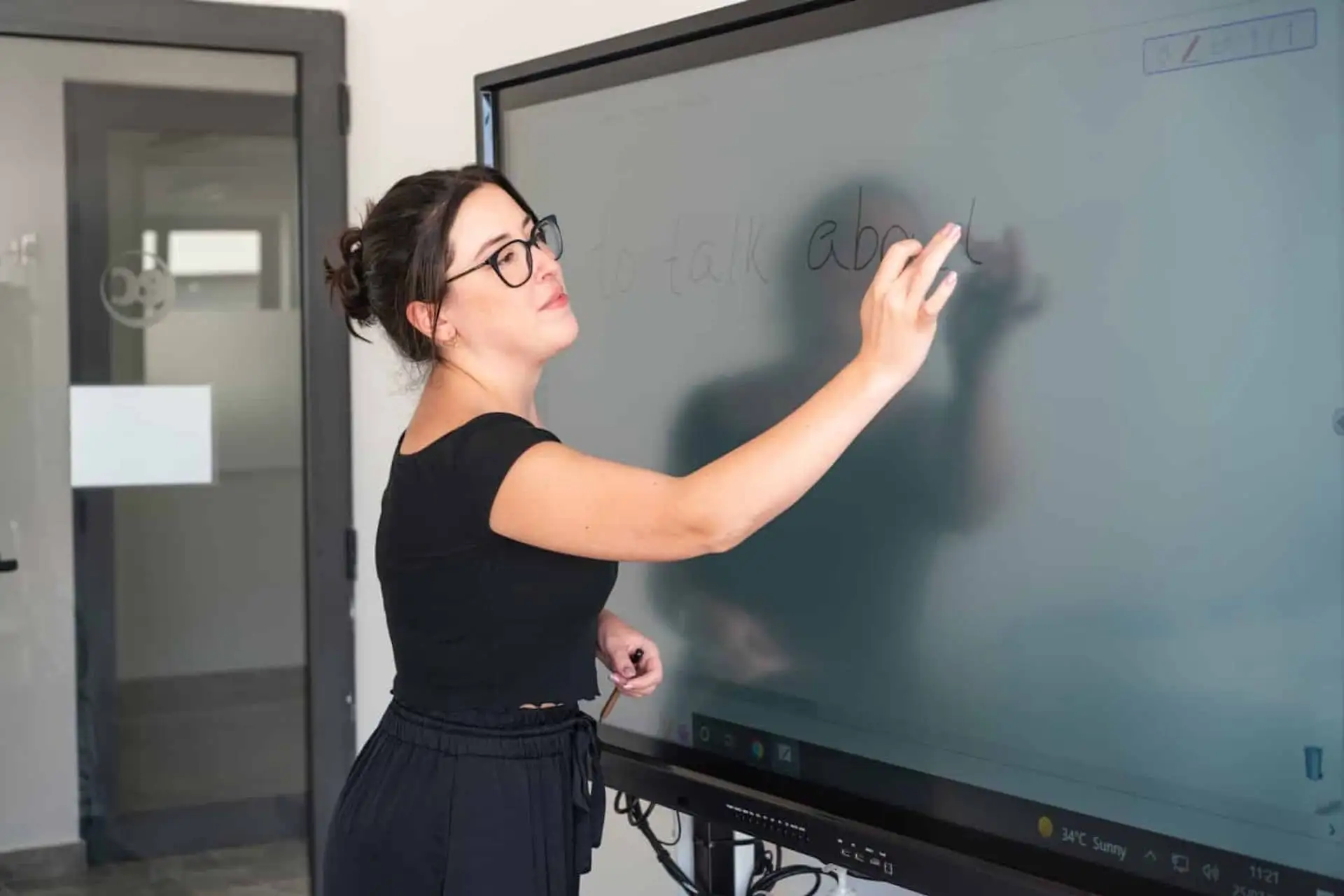 Teacher writing on an interactive board at EC Malta