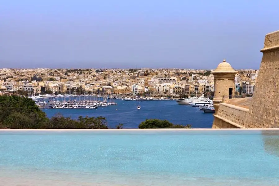 Swimming pool of the Phoenicia Hotel overlooking the Marina and the island of Manoel